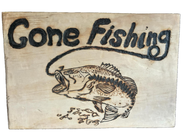 Wood-burned bass fish with the phrase Gone Fishing on wooden plaque